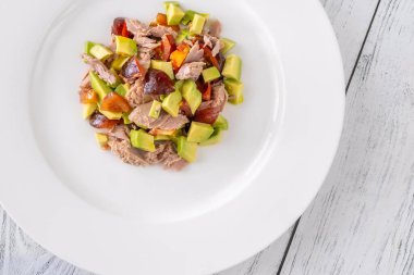 Tuna avocado salad on the white plate