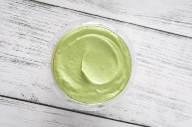 Bowl of avocado mayo on the wooden background