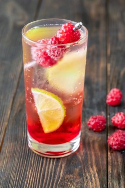 Glass of Raspberry lime rickey cocktail garnished with fresh berries