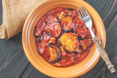Fried slices of eggplant with tomato sauce: top view