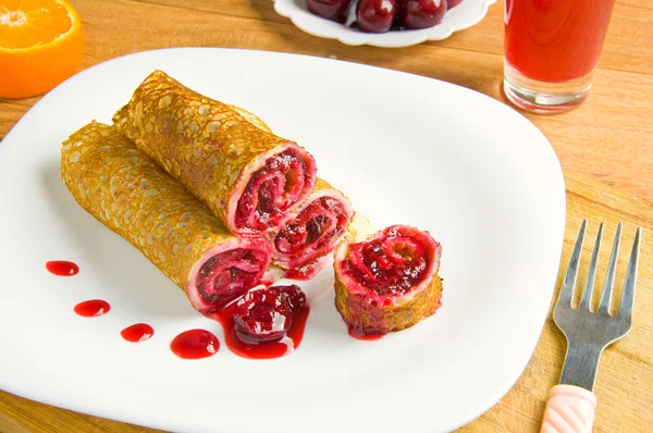 Pancakes with cherry on a white plate — Stock Photo, Image