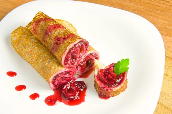 Pancakes with cherry on a white plate — Stock Photo, Image