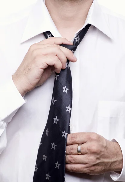 Business man getting ready for work, fixing his tie — Stock Photo, Image