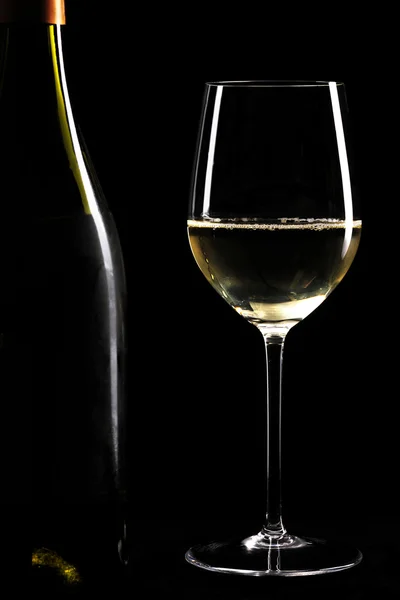 Glass of white wine and bottle — Stock Photo, Image