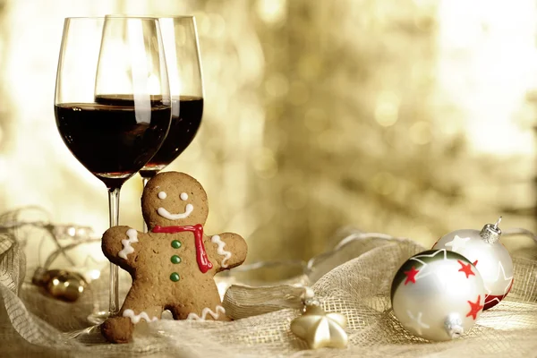 Dois copos de vinho tinto, Gingerbread Man e ornamentos de Natal — Fotografia de Stock