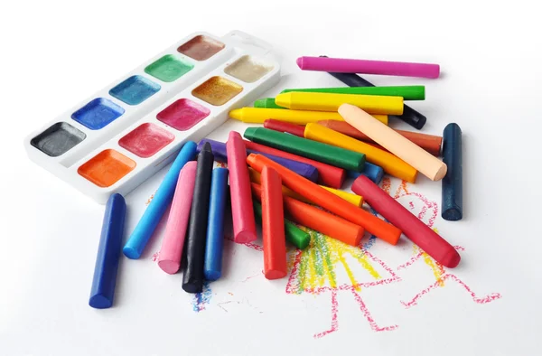 Watercolours and heap of colourfull crayons on white background — Stock Photo, Image
