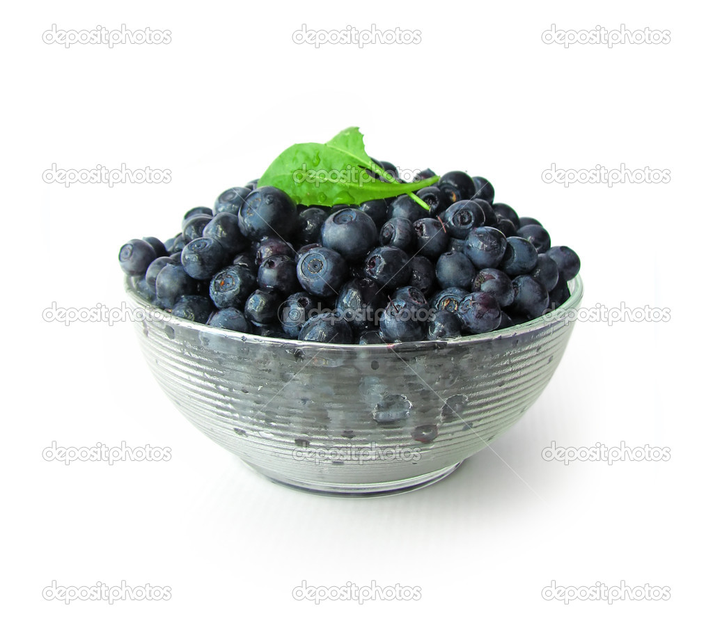 Whortleberries in glass bowl isolated on white background