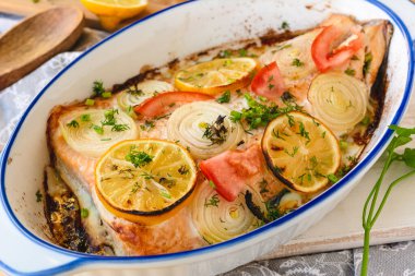 Salmon fillet baked with vegetables. Fish dish