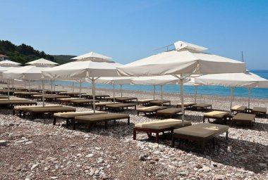 Umbrellas on Sveti Stefan beach, one of the most beautiful beaches in Montenegro. Europe