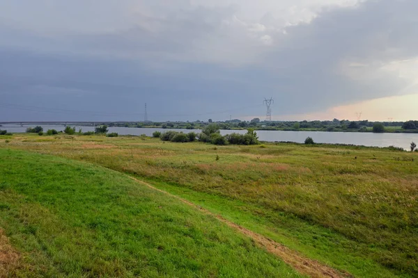 Green meadows by th Vistula River, the longest river in Poland. View from The Gdanska Glowa Watergate in Drewnica
