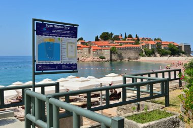 Sveti Stefan, Montenegro - June 6, 2022: Information board on the public beach of Sveti Stefan