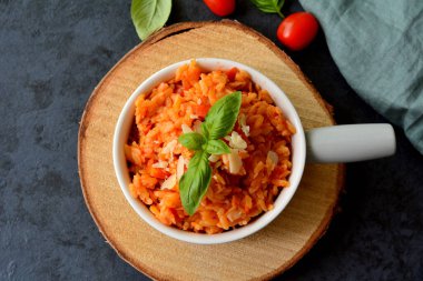 Kritharaki with tomatoes and chicken. Traditional type of Greek pasta shape of rice. Greek version of Italian Orzo