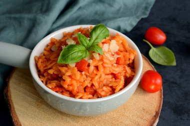Kritharaki with tomatoes and chicken. Traditional type of Greek pasta shape of rice. Greek version of Italian Orzo