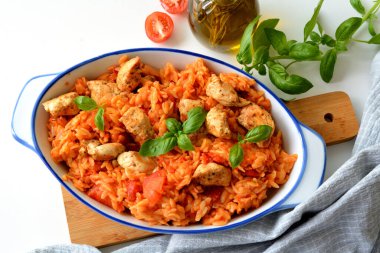Kritharaki with tomatoes and chicken. Traditional type of Greek pasta shape of rice. Greek version of Italian Orzo