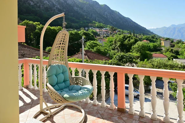 Hanging chair on a holiday terrace in a typical summer apartment in Montenegro
