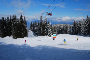 A sunny day on a ski runs in the resort of Bansko in Bulgaria clipart