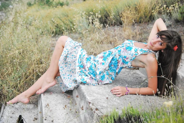 Young girl in a long dress posing among steppe grasses — Stock Photo, Image