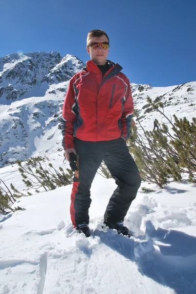 Молодой человек на вершине горы Тодорка на горнолыжном курорте Банско в Болгарии солнечный зимний день — стоковое фото