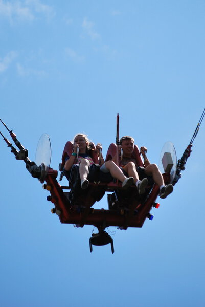 Man and woman having fun at the amusement ride "catapult" in the amusement park "Divo Ostrov" in St. Petersburg