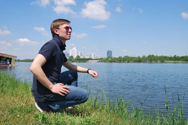 Young man in a blue shirt on the Danube River in Vienna — Stock Photo, Image