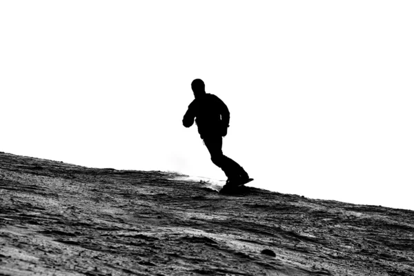 Silueta de un snowboarder bajando de la montaña —  Fotos de Stock