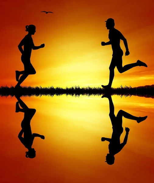 Running people at sunset — Stock Photo, Image