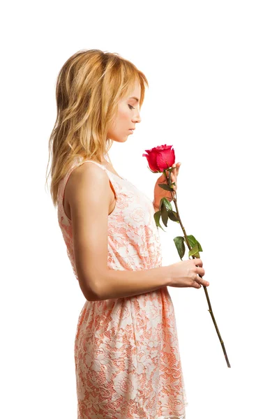 Attractive blonde woman holding a flower — Stock Photo, Image
