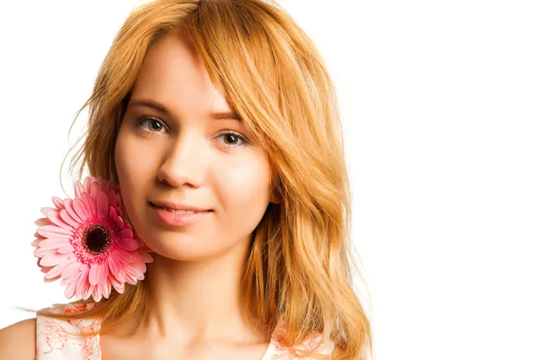 Attractive blonde woman holding a flower — Stock Photo, Image