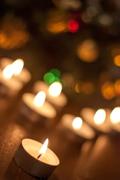 Candles burning near the Christmas tree — Stock Photo, Image