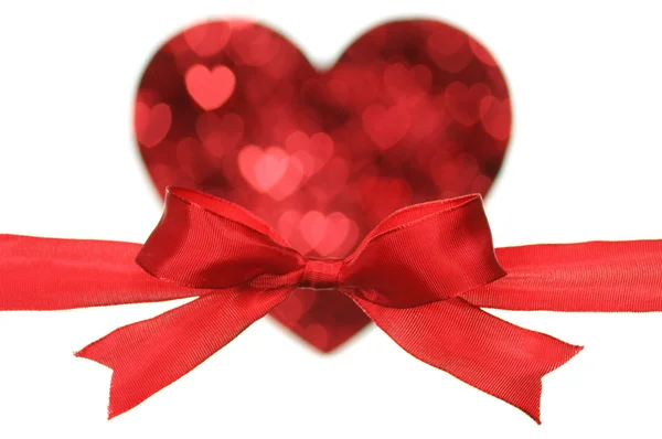 Red bow on heart shape by little heart. — Stock Photo, Image