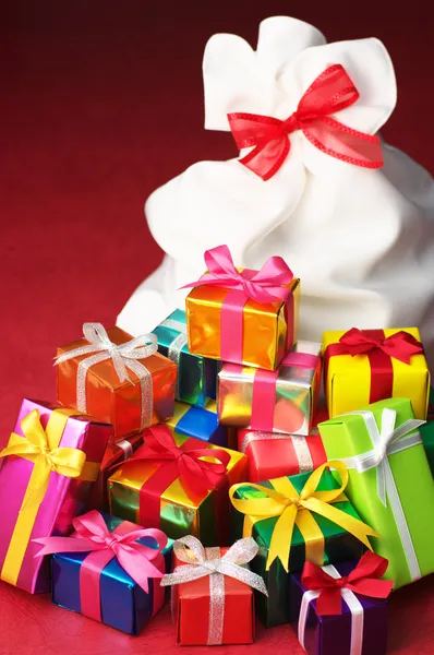 Montón de regalos de Navidad y bolsa blanca . — Foto de Stock