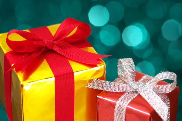 Gold and red gifts on blurry lights background. Stock Image