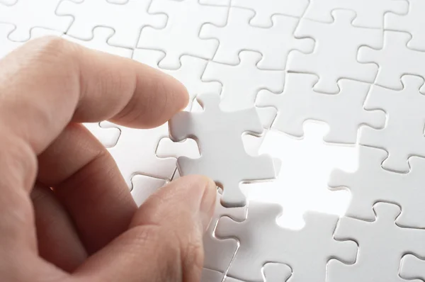 A person matching the last puzzle pieces. Stock Photo