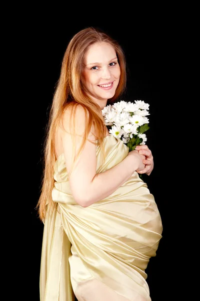 Happy pregnant with a bouquet of chrysanthemums — Stock Photo, Image