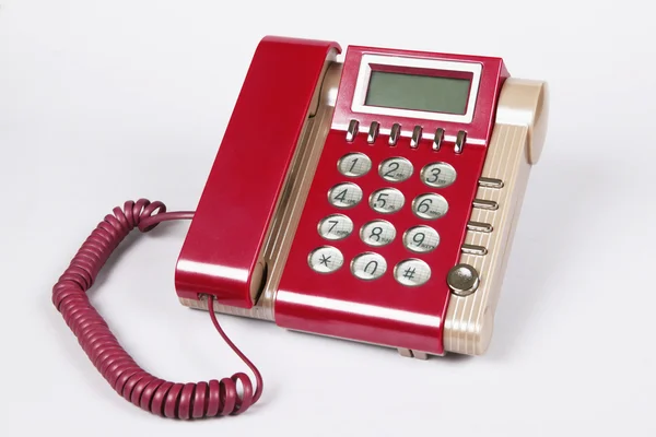 Fehér háttér piros régimódi telefon — Stock Fotó