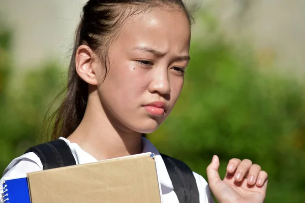 Unhappy Filipina Girl Student With Textbooks