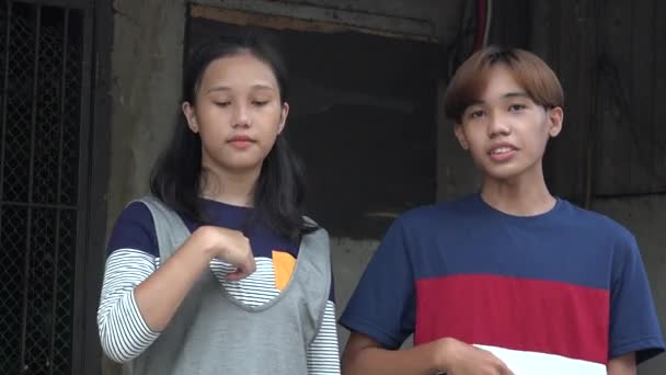 Kristna asiatiska tonårssyskon tecken på korset — Stockvideo