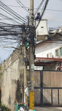 An Electrician Fixing Damaged Telephone Cables