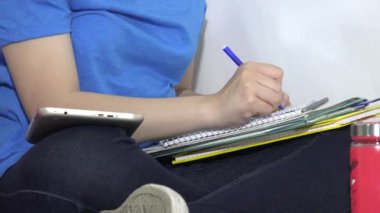 A College Student Writing In Notebook