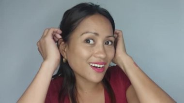 A Pretty Adult Female Fixing Hair