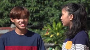 An Asian Friends Or Siblings Talking