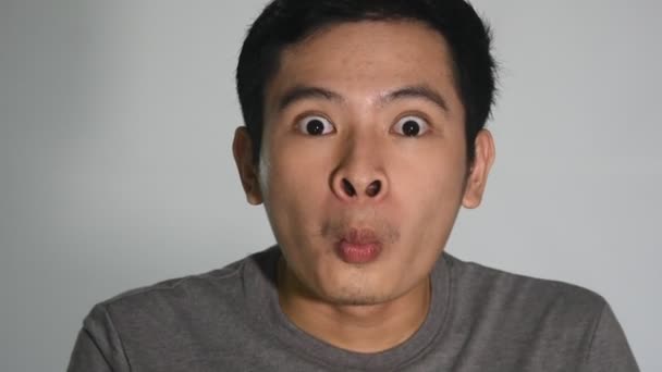 Asian Man Making Funny Faces Closeup Isolated — Vídeos de Stock