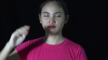 Asian Woman Civilian Saluting In Darkness