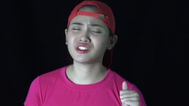An Unhappy Sporty Asian Woman Speaking