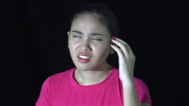 A Confused Asian Woman In Darkness
