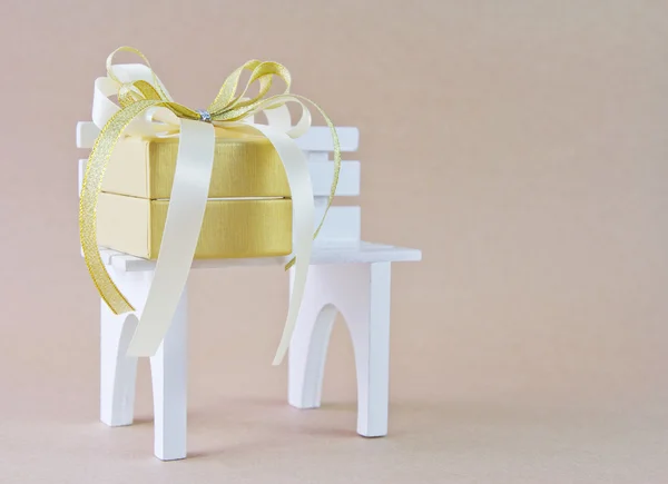Gift box on the white chair — Stock Photo, Image