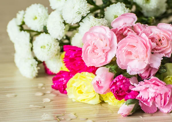 Carnations on wood background — Stock Photo, Image