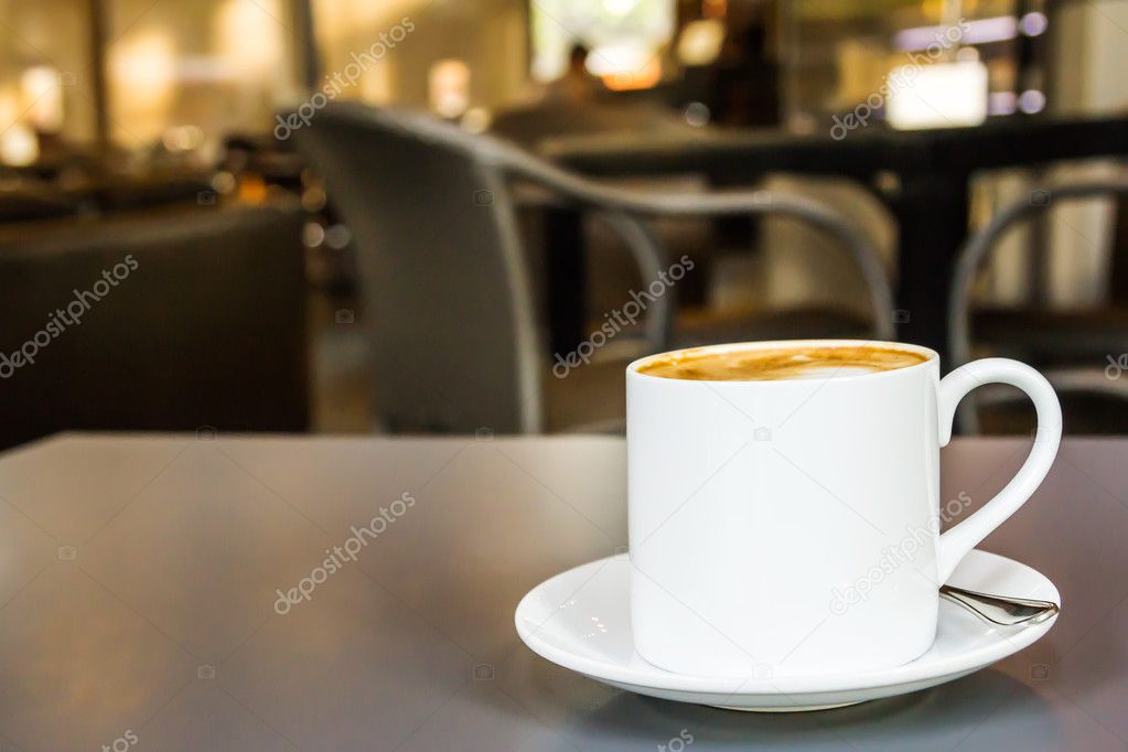 Coffee cup and saucer on table in coffee shop
