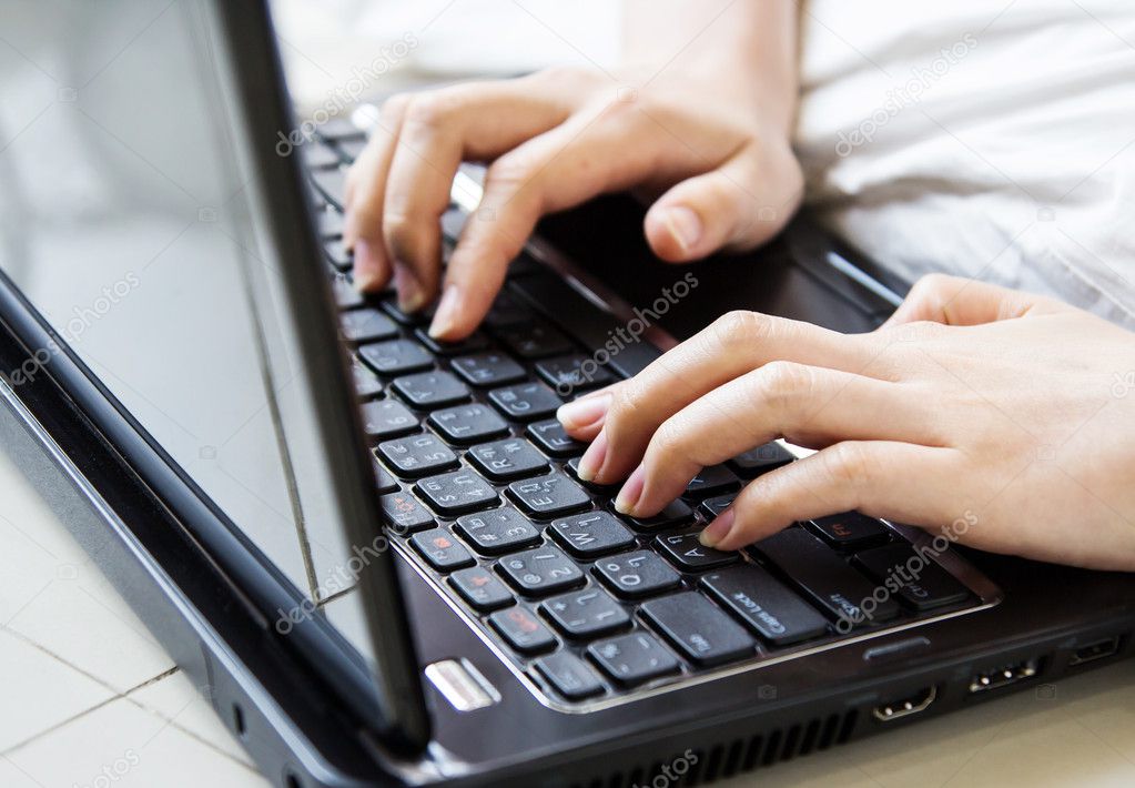 Woman hands typing on laptop keyboard