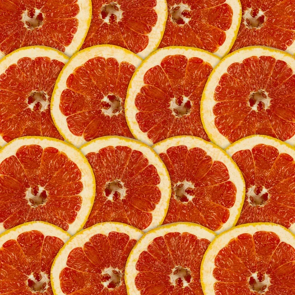 柑橘類果実のグレープ フルーツのスライスと抽象的な赤い背景 — ストック写真